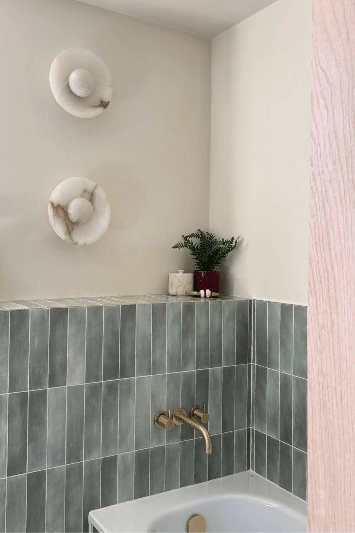 How We Transformed a Small Victorian Bathroom for Family Life - wall light and bath
